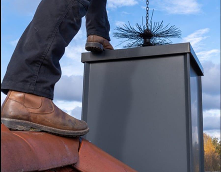 Certified chimney professional inspecting a flue